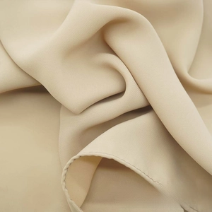 Detailed macro texture of beige satin chiffon scarf showing soft drape and ripple grain