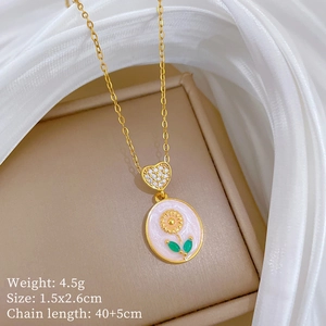 Detail view of gold sunflower pendant with heart connector in elegant jewelry box