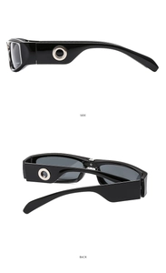 Detail view of rectangular sunglasses showing silver ring decor on black temples