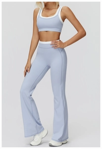 Detailed view of two-tone high waist yoga set featuring flared leggings and sports bra
