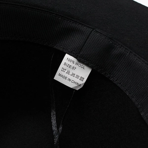 Detail view of the 100% wool felt hat interior featuring a size 57 label and woven band