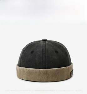 Detail of vintage color-blocked brimless docker hat with washed black fabric and khaki cuff
