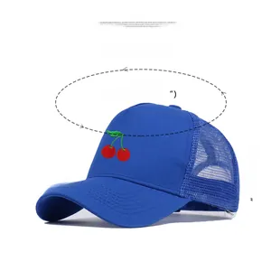 Detail of red cherry embroidery on a blue mesh trucker hat with cotton panels
