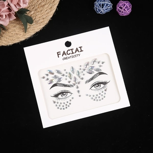 Macro view of iridescent crystal face stickers and laser rhinestones on white card