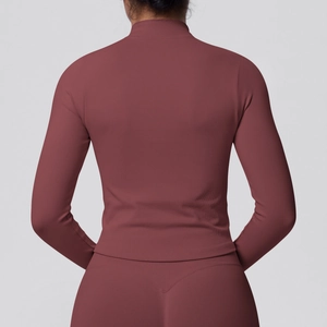 Close-up of ribbed texture and high collar on dark red slim fit yoga jacket for women