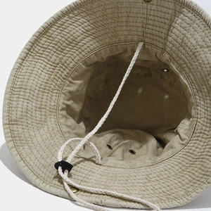 Detail of khaki sun hat featuring breathable metal eyelets and adjustable chin strap