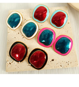 Detailed view of colorful irregular geometric stud earrings on a textured stone tray