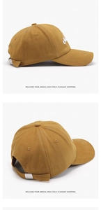 Detail of yellow cotton baseball cap with white embroidery and adjustable metal buckle back