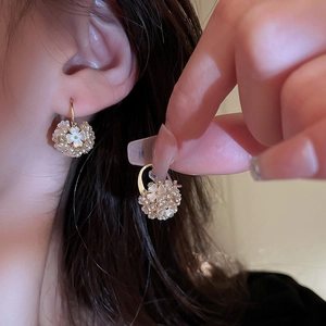 Elegant floral hoop earrings with white acrylic petals and rhinestone gold plating