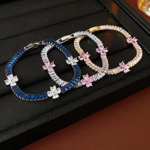 Luxury zircon four-leaf flower bracelet in blue, clear, and pink crystals set in gold