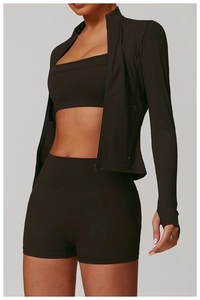 Detail view of long-sleeve yoga jacket with hidden zipper and thumbholes in brown