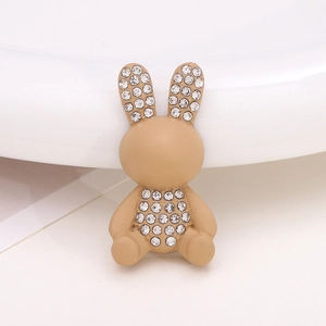 Close-up of a light brown rabbit shoe charm with sparkling rhinestone embellishments