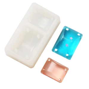 Detail showing silicone mold with rectangular resin pendants in blue and orange glitter