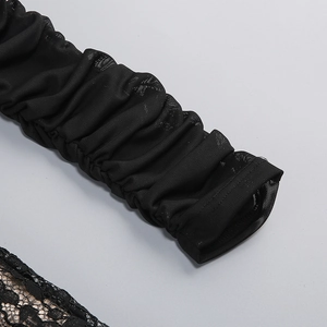 Detailed macro view of black sheer mesh sleeve cuffs with delicate lace floral trim