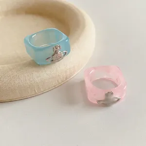 Chic square resin Saturn rings in pastel blue and pink with vintage metal orb accents