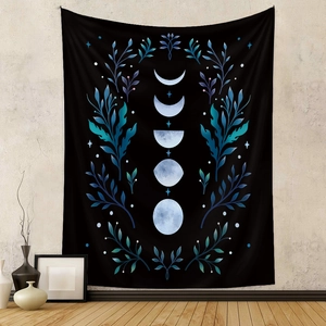 Detail of bohemian black moon phase tapestry with blue botanical accents and moon cycle print