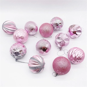 Detail of pink Christmas ornaments with glitter, scales, and stripe textures