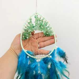 Handmade Tree of Life dream catcher with green crystals and vibrant blue feathers
