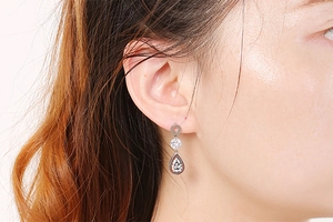 Detail of silver leaf zircon earrings on model showing elegant fit and sparkle