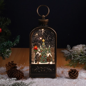 Detail of vintage Christmas lantern with warm LED light and miniature snowy scene decor