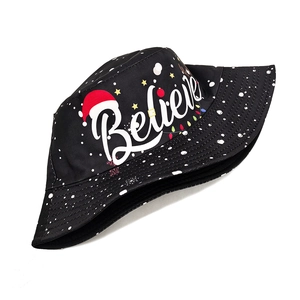 Detail of black Christmas bucket hat with Believe text and festive snowflake patterns