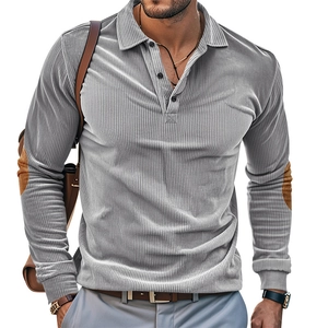 Detail of grey corduroy polo shirt featuring brown suede elbow patches and textured fabric