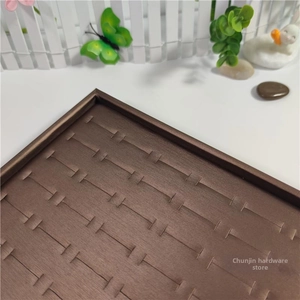 Detail of 100-slot dark brown ring display tray with fine satin texture and slots