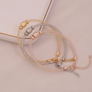 Three-piece metallic mesh bracelet set in gold, silver, and rose gold with metal beads