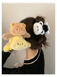 Detailed view of plush animal hair claws featuring bear, chick, and panda embroidered designs
