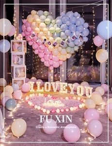 Romantic proposal scene with heart balloon wall, light-up letters, and decorative accessories