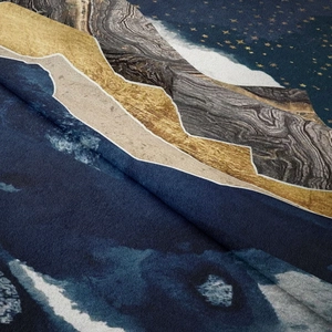Macro detail of the soft fabric texture and artistic mountain print on the wall tapestry