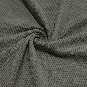 Macro texture of sage green corduroy fabric with vertical ridges and soft thickness