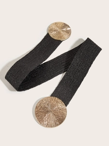 Detail of black elastic woven belt featuring round gold metal buckles with sunburst texture