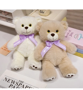 Detail of plush teddy bears with purple polka dot bows and embroidered paw pads