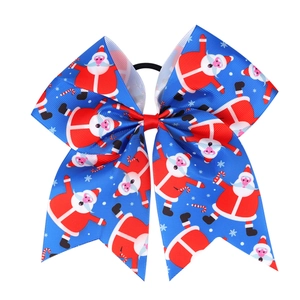 Macro detail of royal blue grosgrain Christmas bow with Santa and candy cane prints