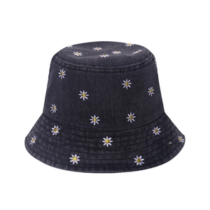 Women's dark denim bucket hat featuring white daisy flower embroidery on a plain background