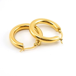 Close-up of polished 18K gold-plated titanium steel hollow hoop earrings on white background