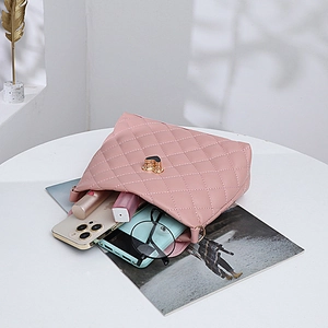 Pink quilted crossbody bucket bag with golden heart lock and spacious interior