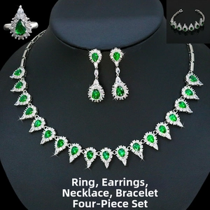 Detail of pear-cut emerald zircon necklace and earring set on a black display model