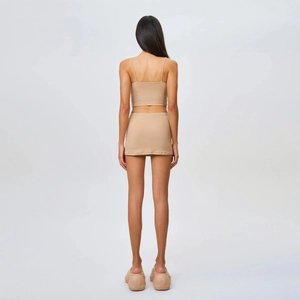 Back view of skin-tone stretchy mini skirt and cropped camisole set for women