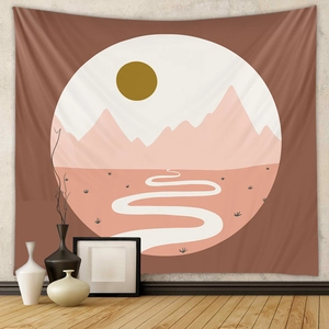 Detail of bohemian tapestry featuring abstract sunset and mountain landscape on a gray wall