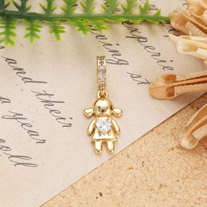 Detailed view of a gold-plated girl pendant with a heart-shaped zircon on vintage paper