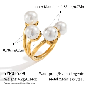 Macro shot of three-strand gold stainless steel ring featuring four white pearls