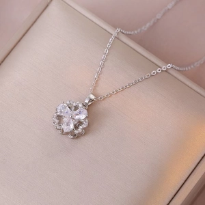 Detailed macro view of a rotating flower pendant with sparkling zircons in a jewelry box