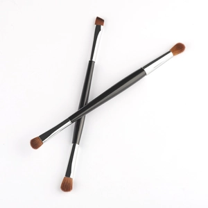 Detail of dual-ended makeup brushes with wooden handles and dual-purpose bristles