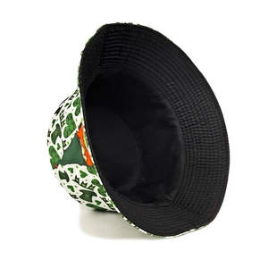 St. Patrick's Day bucket hat with green shamrock and gnome prints on white canvas