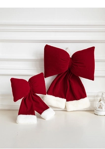 Detailed view of burgundy velvet Christmas bows with white faux fur trim in two sizes