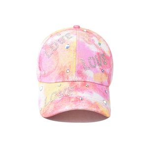 Detail of pink tie-dye baseball cap with sparkling rhinestone LOVE lettering and colorful gems