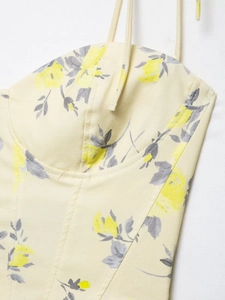 Detail of yellow floral poplin top featuring fine stitching and delicate straps
