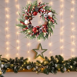Christmas wreath with pine cones and red berries on a festive glowing background